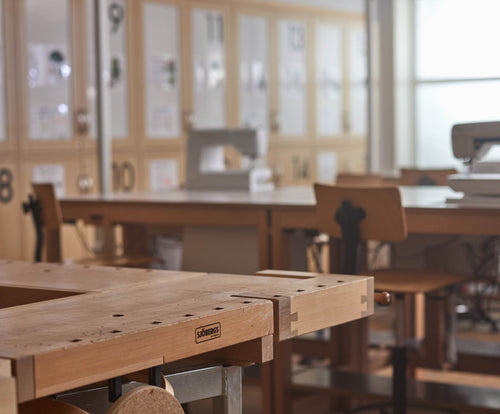 Woodwork classroom with wooden workbenches