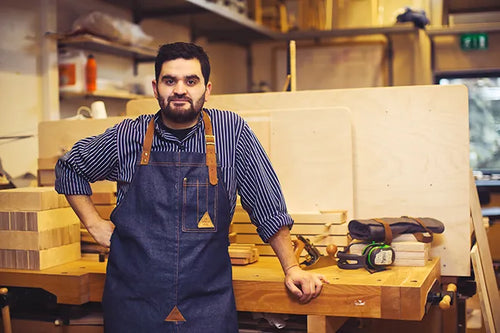 Sebastián of Ekorre Möbler in an apron at his workbench