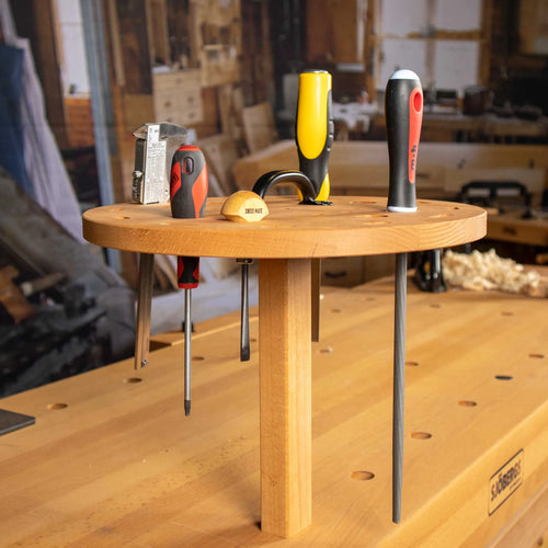Sjöbergs Tool Holder with screwdrivers in the bench dog holes of a workbench
