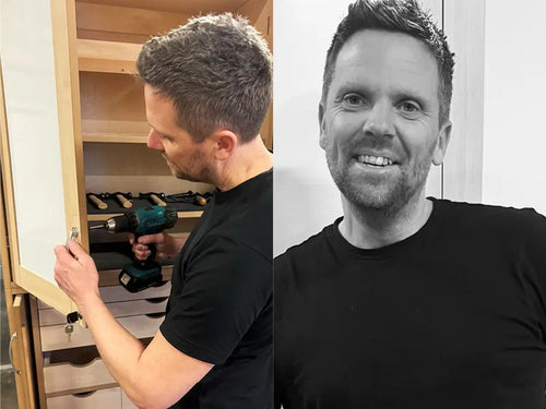 David Hassel servicing a cabinet in a classroom, next to a portrait of him
